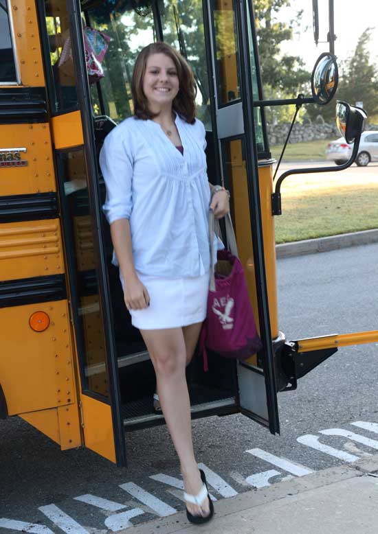 Ninth-grader Rebecca Kasabian steps off a Bromfield bus on the first day of school.