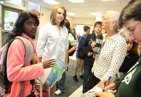 From left: Bhavani Hodgkins and Rebecca Casabian pick up new assignment books from teachers Davida Bagatelle and Julie Nocka.