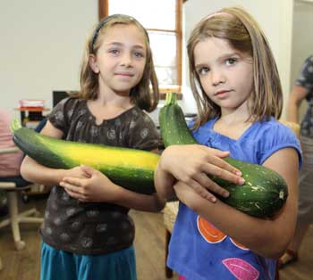 The Clark sisters with their giant zucchinis. (Photo by Lisa Aciukewicz)