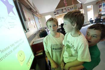 From left: Kenny, Jason, and Michael Morin check out a new SMARTBoard at HES. (Photo by Lisa Aciukewicz) From left: Kenny, Jason, and Michael Morin check out a new SMARTBoard at HES. (Photo by Lisa Aciukewicz)