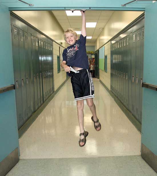 Colin Cleary jumps for joy on his first day as a fifth grader.