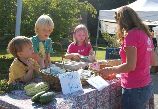 From left, Isaac Greayer, Jack Sennott, and Meredith Greayer sell eggs at the Farmers' Market on Sept. 5.