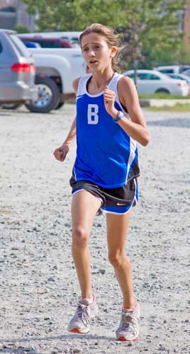 Eighth-grader Alexia Lipman (left) and junior Mimi Narbonne compete in a recent cross country meet.
