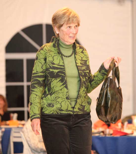 Council on Aging volunteer Marie Finnegan shows off an intarsia pattern jacket by 600 West with a matching green turtleneck sweater by Tribal.