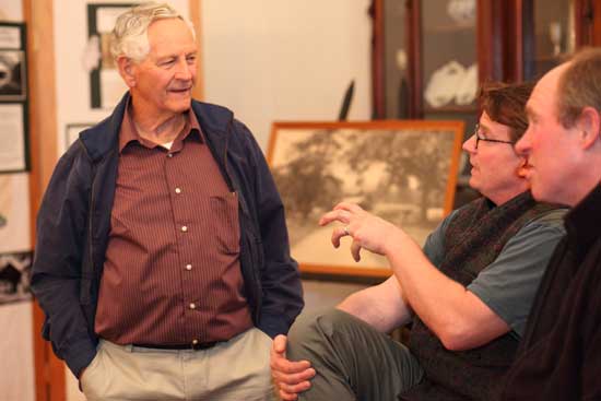 (From left) Ken Van Wormer, Jim Burns, and Larry Doe talk at the Oct. 2 opening of “Covered Bridges” an exhibit at the Historical Society.