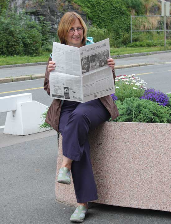 Former Harvard resident and Bromfield social studies teacher Marilou Spash reads the Press in Oslo while leading a trip to Scandinavia this summer.