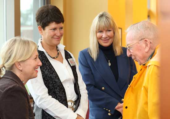 Melissa Yahia, Sue Ginouves, and Chris Colley speak with Jeff Harris at the opening of the exhibit “Barn Raising of a Different Kind” on Oct. 5. featuring work by local artists Sue Ginouves, Sue Fitterman, Colleen Pierce, and Judy Warner.