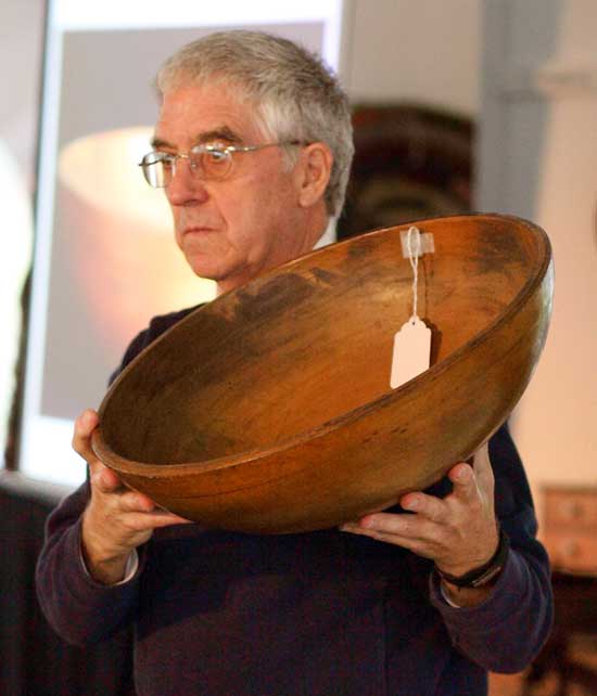 Keilah Coom of Willis Henry Auctions displays a turned Shaker bowl.