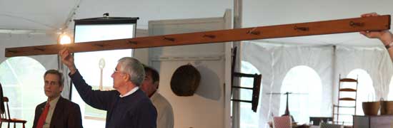 The auctioneers display a 13-foot long Shaker peg board.
