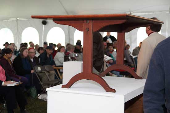 The auctioneers display a 13-foot long Shaker peg board.
