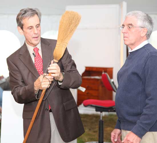 Willis Henry displays a broom and hanger made at the Shaker village in Canterbury, NH. The broom sold for $600.