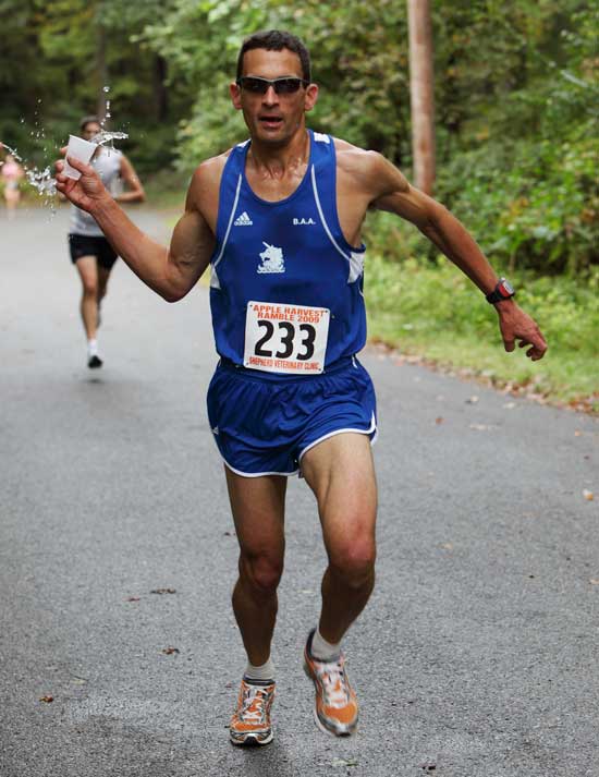 Jon Schoenberg of Myrick Lane grabs a quick drink on Under Pin Hill Road at the 2-mile mark of the 10-mile Apple Harvest Ramble on Oct. 4.