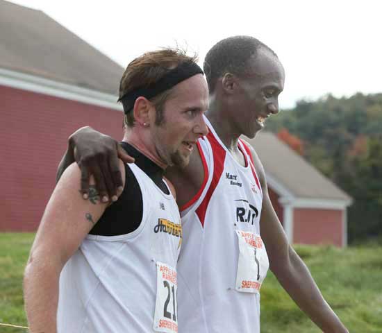 Race winner Michael Brouillette (left) and second-place finisher Ben Ndaya embrace at the finish line of the 10-mile Apple Harvest Ramble on October 4.