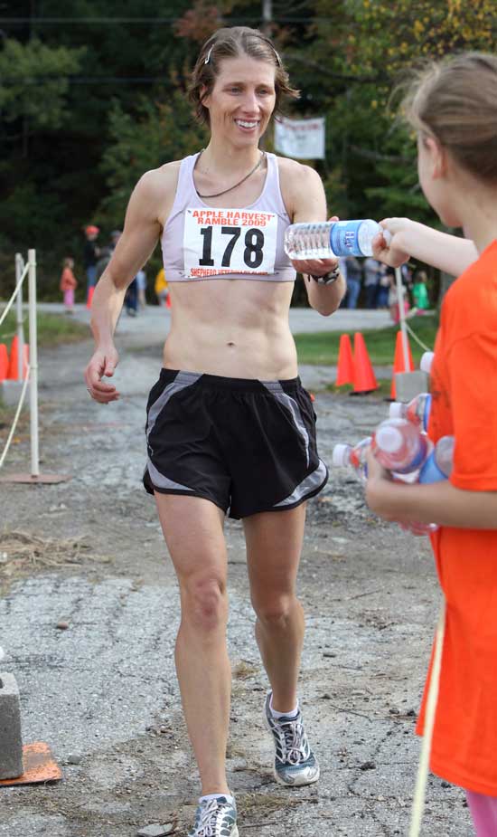 Yolanda Flamino of Hancock, N.H. is the first woman to cross the finish line at 1:01:54.