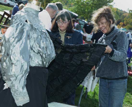 Susan Pescatore (left) and Josie Carothers check out an antique skirt.