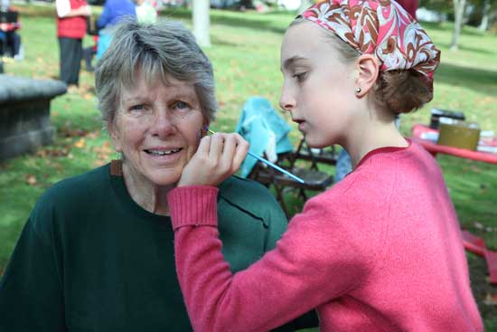 Pat Jennings gets her face painted by granddaughter Patrice Mitchell.