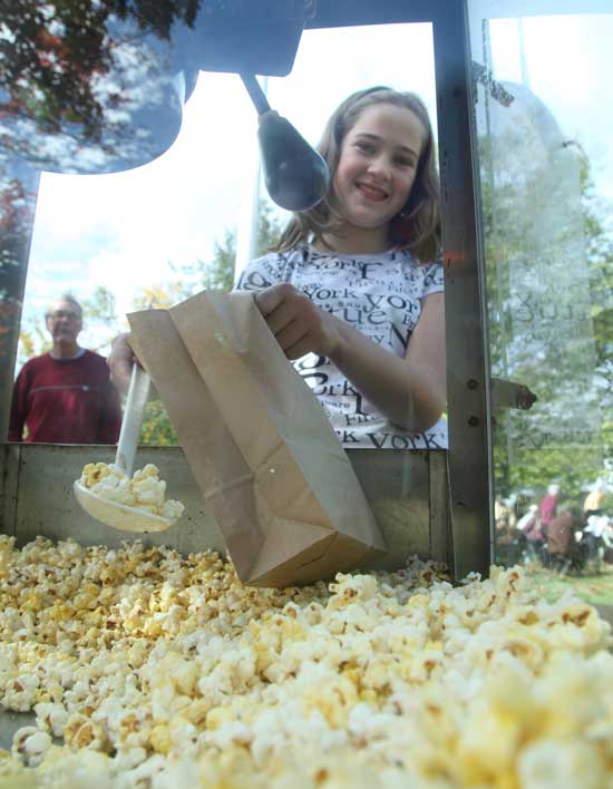 Jane Sullebarger fills bags of popcorn.