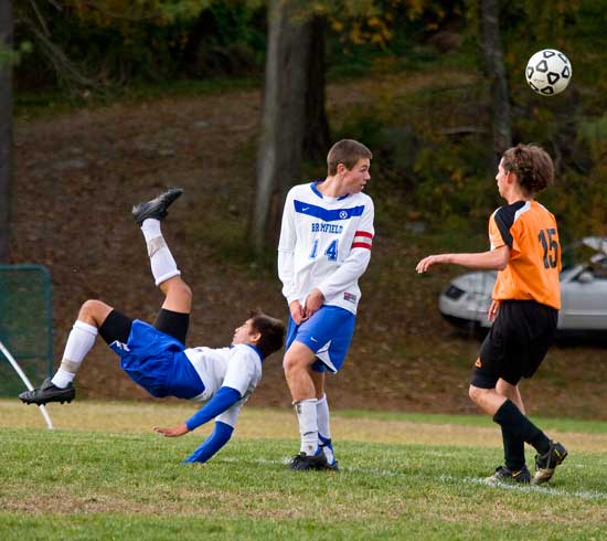 From left, Derek Silver completes a bicycle kick as teammate Cody Osgood watches it fly over an opponent in a game against Gardner on Oct. 14. Silver’s kick resulted in a goal for Bromfield.