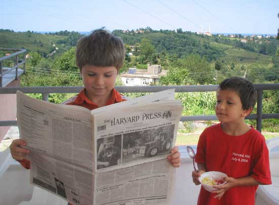 Pasha and Timur Sahin of Littleton Road check out the Harvard Press while on vacation at their grandparents’ hazelnut farm in the village of Kusca in northern Turkey.