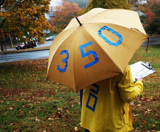 An event to raise awareness on climate change was held by 350.org on the Common in an October rainstorm. (Photo by Sue Fitterman)