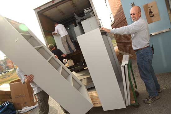Facilities Manager Mark Force helps unload office furniture at the Bromfield School on Oct. 22. Liberty Mutual donated approximately $10,000 worth of surplus office furniture to the schools and to Fruitlands Museum.