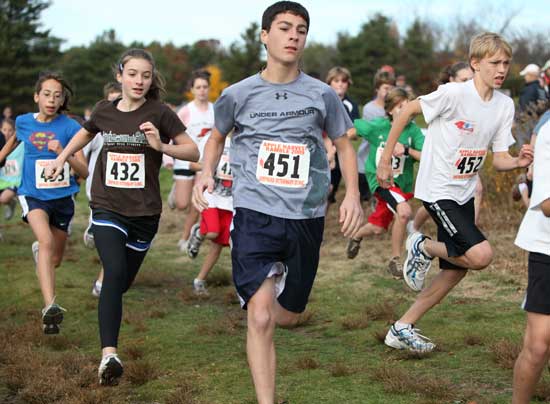 Off the starting line for the 11- to 14-year-old age group as part of the Harvard Road Race Association’s kids cross country fun run on Nov. 1 are, left to right: Maddie Beckman-Ogut, Sophia Collins, Nicholas Piccioli, and Price Day. Collins would go on to win the 1.25-mile race with a time of 8:42 and Day would win the 2.2-mile race with a time of 14:22.