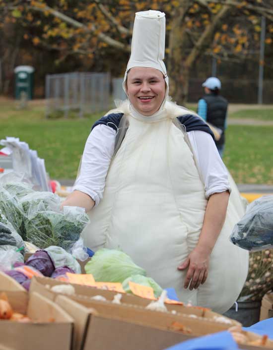 Dressed as a garlic bulb, Michele Schroeder of Applefield Farm sells produce at the Farmers' Market on Halloween.