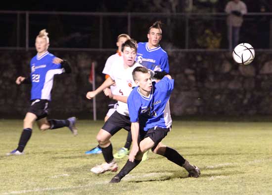 Bromfield senior Cody Osgood (center) rushes to gain control of the ball in Bromfield’s final game of the season on Nov. 11. The team lost to Maynard 2–4 in the District Semifinal to end the season with a record of 12–5–1. (Photo by Lisa Aciukewicz)