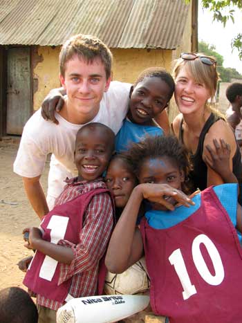 Sam Peisch (left) poses with some Zambian children and a friend. (Courtesy photo) Sam Peisch (left) poses with some Zambian children and a friend. (Courtesy photo)
