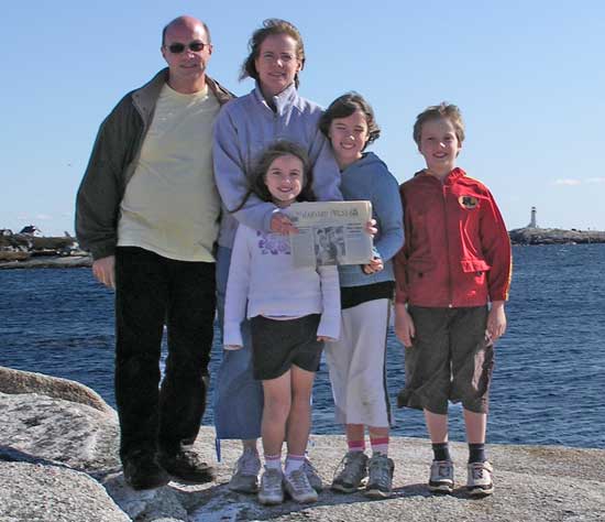 Trevor Smedley, Jane Parker, and their children Gwyneth, Sarah, and Pierce, with the Press near Peggy’s Cove, Nova Scotia, Canada. The family plans to relocate to the Boston area and hopes to settle in Harvard. They picked up the copy of the paper when visiting the General Store in August
