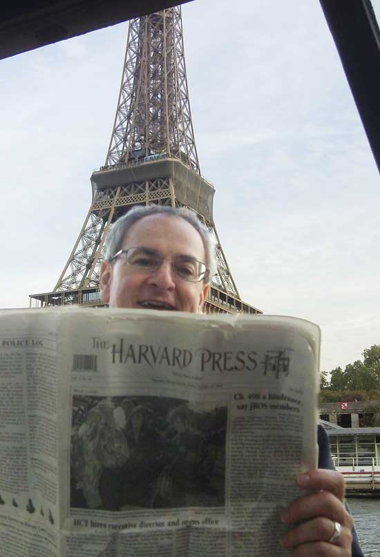 West Bare Hill Road resident Nick Kouros reads the Press last October in the shadow of the Eiffel Tower in Paris.