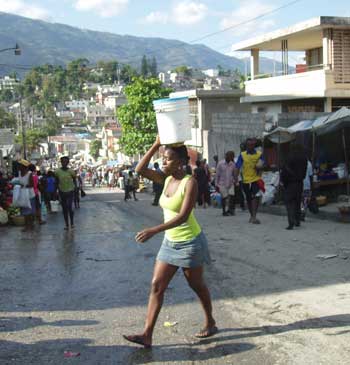 A girl balances a bucket of water on her head as she crosses the street in Port-au-Prince before the earthquake. (Photo by Libby Levison) A girl balances a bucket of water on her head as she crosses the street in Port-au-Prince before the earthquake. (Photo by Libby Levison)