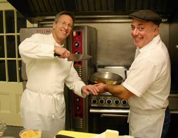 Chefs Paul Correnty and Chris Basile ham it up in the kitchen at Fruitlands while cooking for their cider dinner on Jan. 23. (Photo by Barbara Kemp) Chefs Paul Correnty and Chris Basile ham it up in the kitchen at Fruitlands while cooking for their cider dinner on Jan. 23. (Photo by Barbara Kemp)