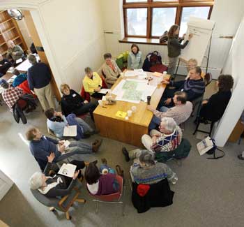 Participants sit in groups brainstorming future uses of town buildings at a charrette held in the old library on Jan. 30. (Photo by Lisa Aciukewicz) Participants sit in groups brainstorming future uses of town buildings at a charrette held in the old library on Jan. 30. (Photo by Lisa Aciukewicz)