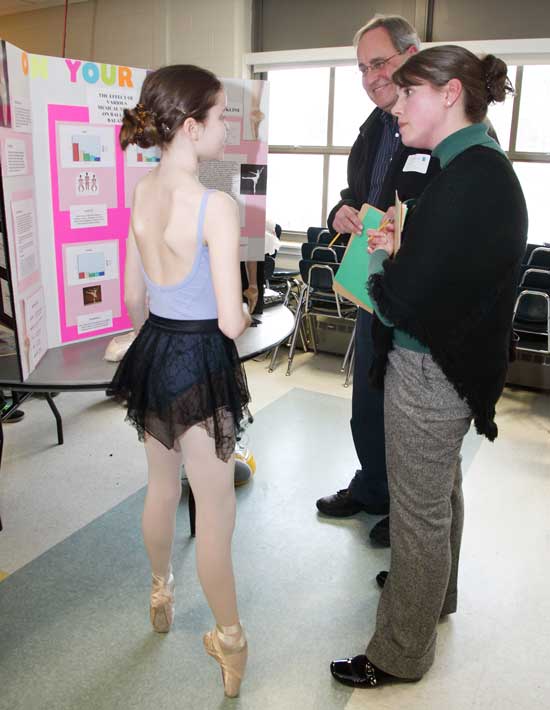 Sixth grade ballerina Hannah Kline speaks with judges John McGoldrick and Bridget Elliot about her project, "The Effect of Various Music Styles on Balletic Balance."