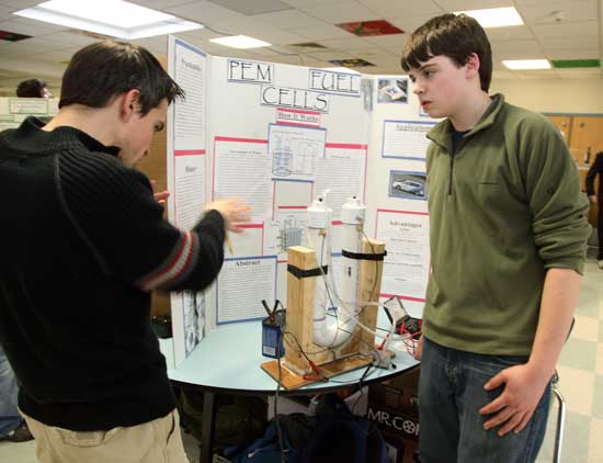 11th-grader Josh Zimmer listens to a judge's questions about his project on PEM fuel cells.