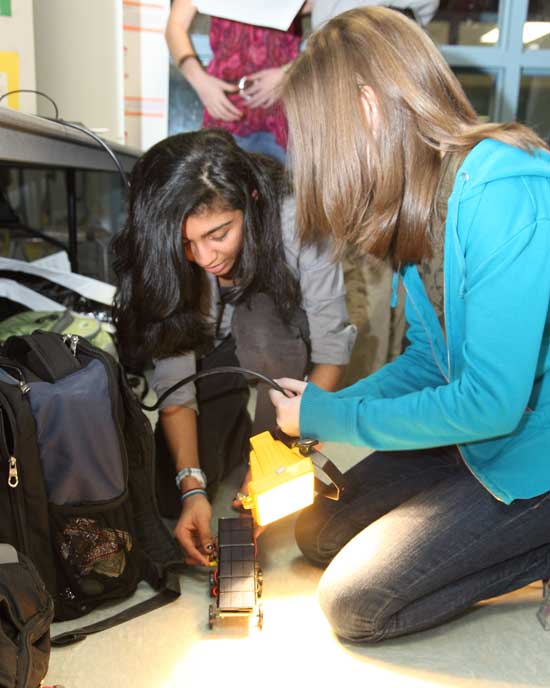 Ninth-graders Vishwa Rasania (left) and Janet Sorrells demonstrate how their solar-powered vehicle works
