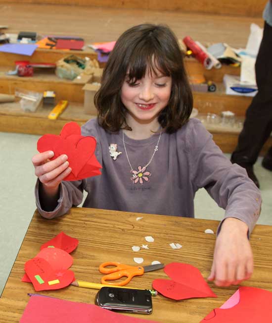 Second-grader Samantha Schoenberg creates a handful of Valentines at the For Art's Sake Valentine-making event at the elementary school on Feb. 6.