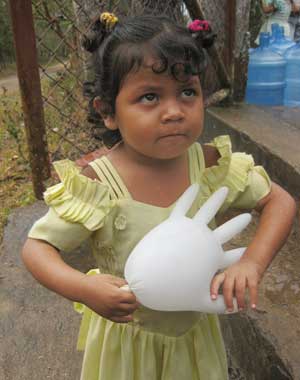 A little girl waiting to see the doctors during the 2009 medical trip plays with a blown-up medical glove. (Coutesy photo) A little girl waiting to see the doctors during the 2009 medical trip plays with a blown-up medical glove. (Coutesy photo)