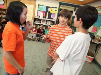 Joanna Young (left) and Ben Siddiqui (right) try to spread a rumor to Ben Marinelli during a role-playing exercise. “Do you really think that?” asks Marinelli, as he effectively blocks the rumor from spreading further. (Photo by Lisa Aciukwicz) Joanna Young (left) and Ben Siddiqui (right) try to spread a rumor to Ben Marinelli during a role-playing exercise. “Do you really think that?” asks Marinelli, as he effectively blocks the rumor from spreading further. (Photo by Lisa Aciukwicz)