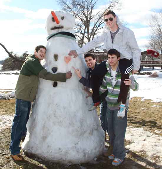 From left, Dan Ockene, Ben Landry, Nick Ashe, and Zach Clements (on Nick’s shoulders) pose with a giant 8-foot 7-inch snowman they created on the lawn in front of Bromfield during February vacation.