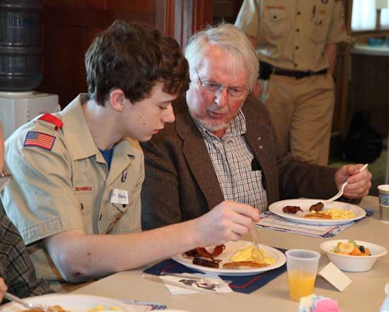 Boy Scout Ryan Kennedy (left) chats with Own Sponagle as they eat breakfast at the Boy Scout's annual breakfast for senior men held at the Hildreth House on March 7.