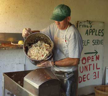 Cider champ Phil Rymsha prepares apples for cider. (Photo by Eileen Kronauer) Cider champ Phil Rymsha prepares apples for cider. (Photo by Eileen Kronauer)