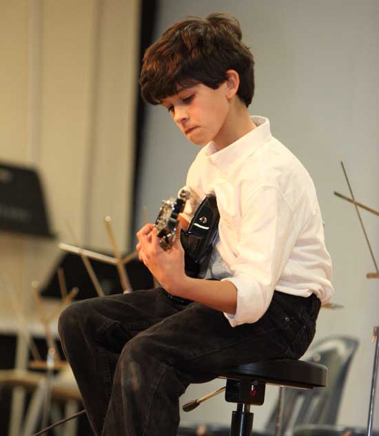 Joey D'Amore plays a guitar solo at the fifth grade fundraiser for Nature's Classroom on March 22.
