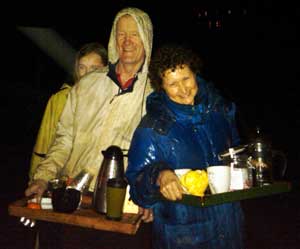 From left: Willow Road residents Nicole Chapman, John Chapman, and Patty Ruze play good Samaritans, offering hot beverages to rain-soaked National Guard troops who placed sandbags on the dam well into Tuesday night. (Courtesy photo by Bob Mignard) From left: Willow Road residents Nicole Chapman, John Chapman, and Patty Ruze play good Samaritans, offering hot beverages to rain-soaked National Guard troops who placed sandbags on the dam well into Tuesday night. (Courtesy photo by Bob Mignard)