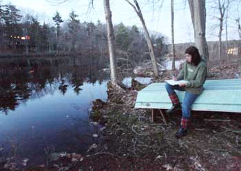 Elizabeth Swain listens for frogs as she sits next to Bare Hill Pond during a frog count on April 5. (Photo by Lisa Aciukewicz) Elizabeth Swain listens for frogs as she sits next to Bare Hill Pond during a frog count on April 5. (Photo by Lisa Aciukewicz)