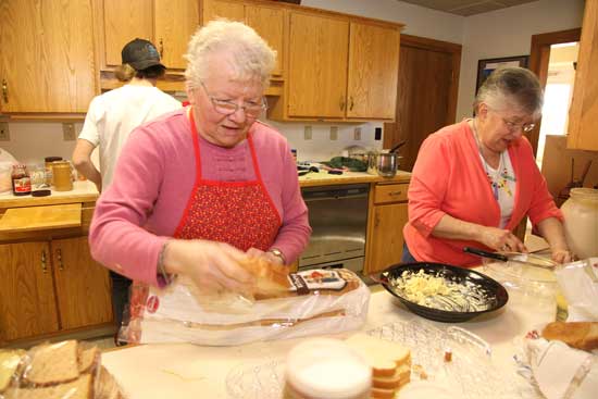 Betty Stone (left) and Margaret Zoller prepare sandwiches for the walkers.