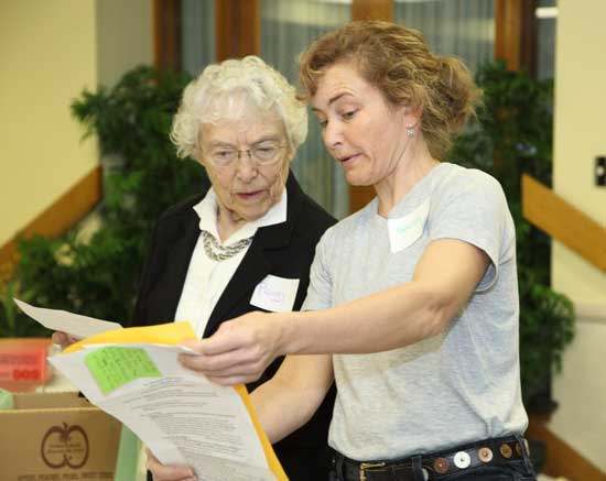Peggy Braat (left) and Becca Day-Newsham look over registrations.