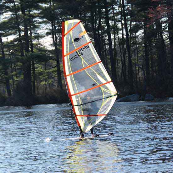 A windsurfer on Bare Hill Pond takes advantage of some unusually warm April weather. (Photo by Robert M. Barrett)