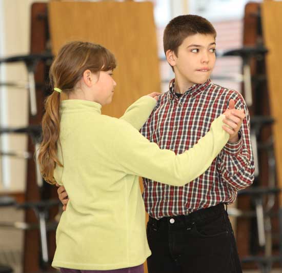 Michelle Ginouves and Ben Neville practice some steps.
